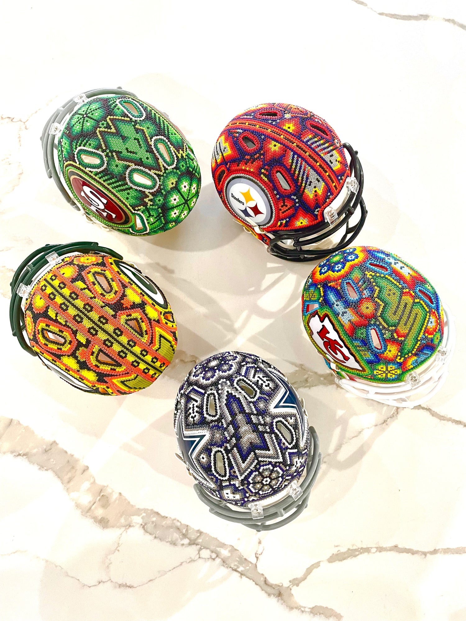 Huichol art decorated NFL helmets